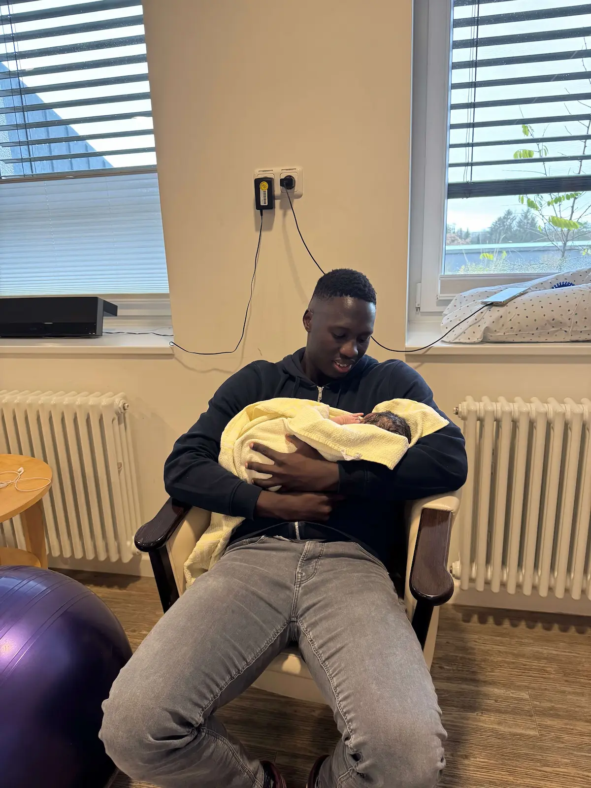 Hudson holding newborn Verena Moraa at the hospital